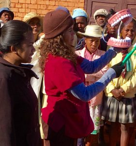With the help of a translator, a team member teaches proper dental care.