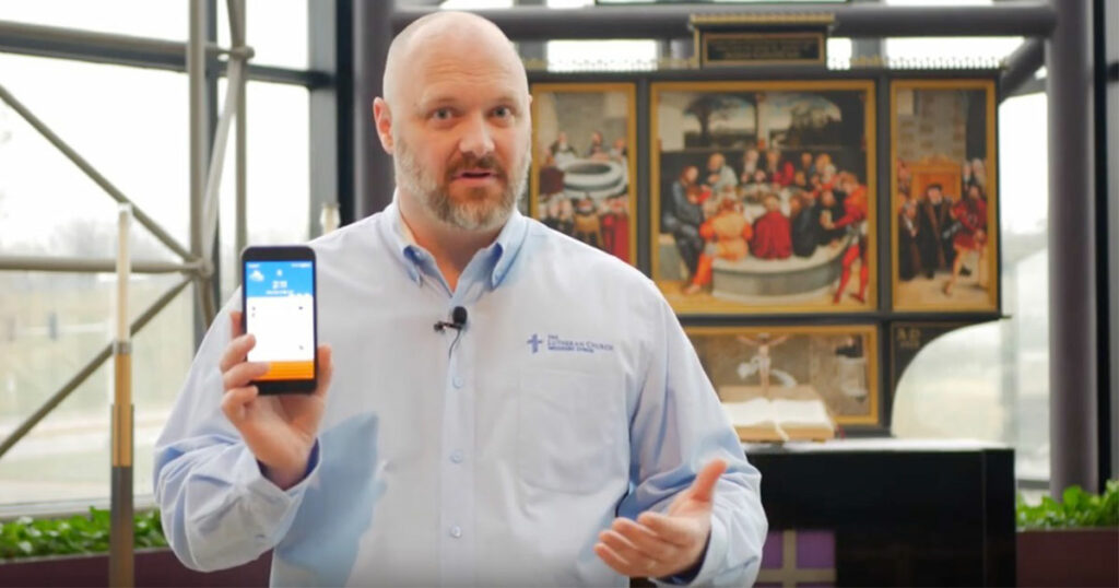 Man explaining to camera while holding cellphone